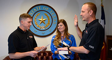 Chairman Bryan W. Shaw, Ph.D., P.E., swears in new Commissioner Zak Covar, as Covar's wife, Krista, looks on. Chairman Bryan W. Shaw, Ph.D., P.E., swears in new Commissioner Zak Covar, as Covar's wife, Krista, looks on.