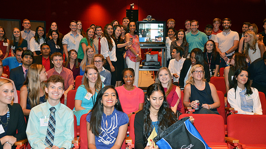 Alison Leland surrounded by this year’s interns—including those on the TV screen, via teleconference from TCEQ regions.