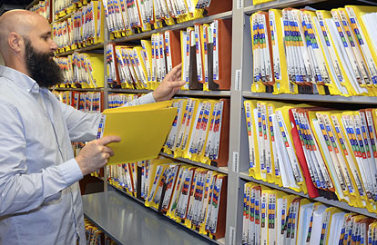 Michael Chamberlain, TCEQ Records Management Team, retrieves a folder in the Central File Room. The file room stores the TCEQ's critical files and has viewing space available for the public. For more information, visit the file room webpage (www.tceq.texas.gov/agency/data/records-services).