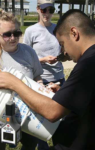 The recon team tags a bucket, which simulates a hazmat container, with relevant data.