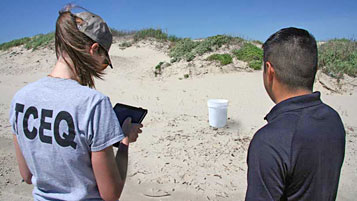 Andrea Gustavson, TCEQ team lead, and National Guardsman Jorje Hernandez enter information about a simulated hazmat container into the Response Manager database as part of the hurricane response exercise organized by the Natural Disaster Operational Workgroup.