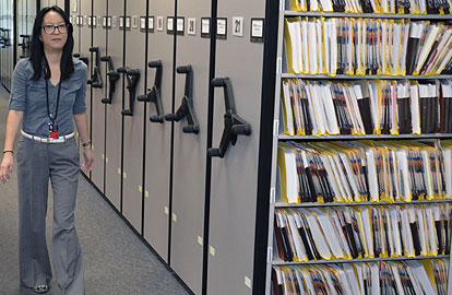 Contract worker Yukio Nemoto walks along the rolling stack shelving in the TCEQ's Central File Room. The stacks allow for more files to be stored in a smaller space.