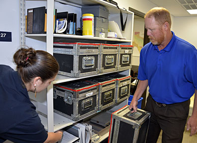 Rebecca Tyra and Jason Neumann prepare summa air quality sampling kits for use to test air in residents’ homes.