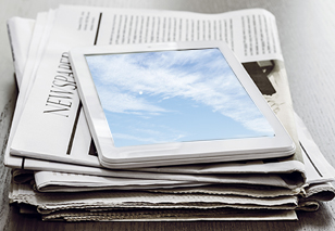 Newspaper and tablet.