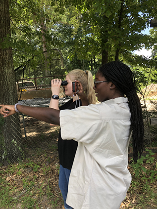Kendra Baldwin (front) and fellow intern Bailey Bertolino investigating at an emissions event site.