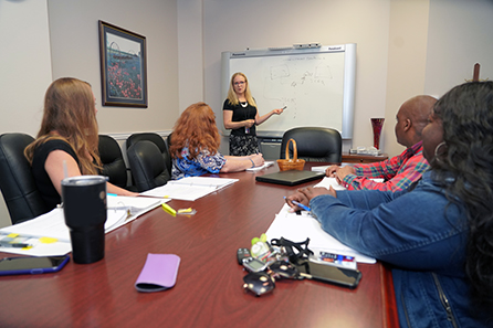 Jaya Zyman leads a meeting with her staff and TCEQ attorneys to discuss jurisdiction between TCEQ and the Texas Department of Licensing and Registration with respect to well drilling and water treatment specialists licenses.