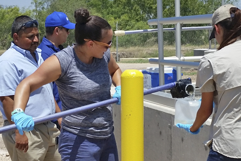 Jackie Keltner, an environmental investigator in TCEQ’s Harlingen region, collects effluent samples at a wastewater treatment plant.