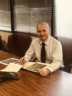 Jaime Garza prepares material and maps for a meeting with Harris County officials.
