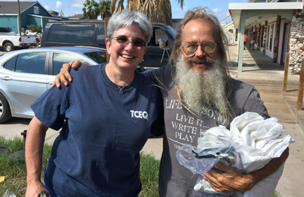 Susan Clewis hands out safety supplies to a Port Aransas resident after Hurricane Harvey.