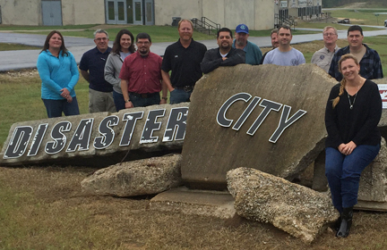 Susan Jablonski (in front, seated on the rock) attends a Disaster City exercise.