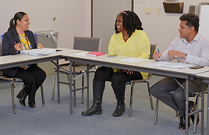 Yolanda Davis (center) meets with her staff to discuss financial issues.