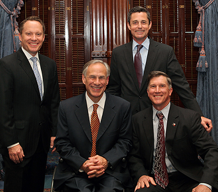 TCEQ Commissioners Toby Baker (standing, left), Jon Niermann (standing, right), and Chairman Bryan W. Shaw, Ph.D., P.E., (seated, right) meet with Texas Gov. Greg Abbott in May at the Capitol during the governor’s visit with recipients of the Texas Environmental Excellence Awards, the state’s highest environmental award.