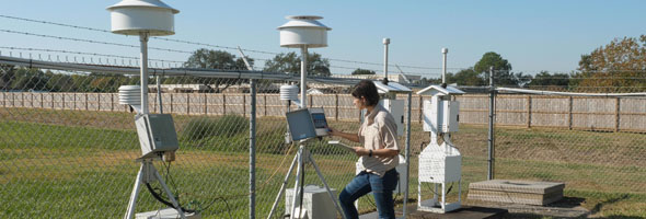 Erin McDonald, a work leader in TCEQ’s Monitoring Division, checks on a stationary air monitoring site.