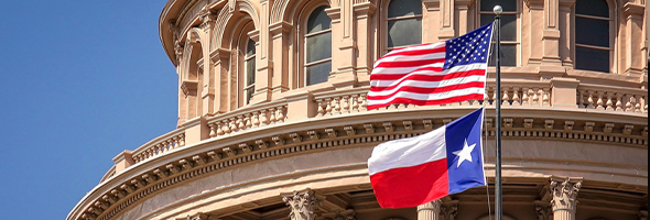 American and Texas Flags fly at Texas Capitol