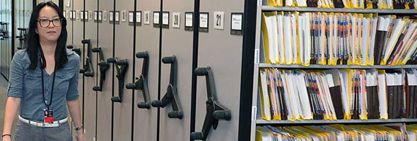 Yukio Nemoto walks along the rolling stack shelving in TCEQ's Central File Room.