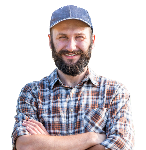 Man in plaid shirt with ball cap.  Crossing his arms.