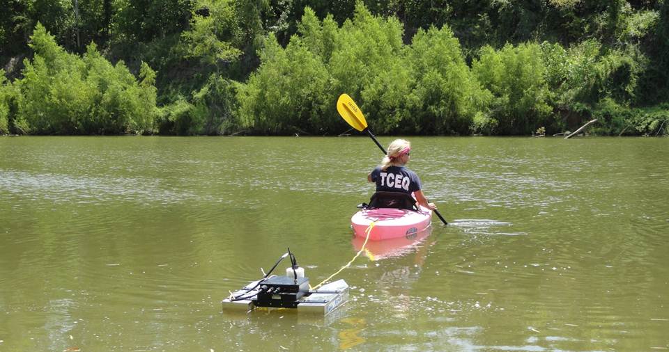 TCEQ staff towing a doppler flow instrument