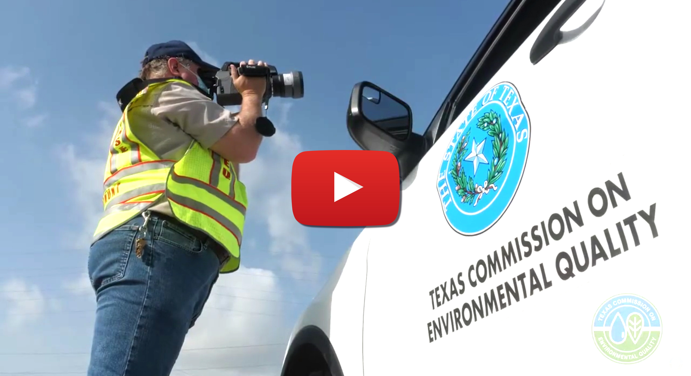 A TCEQ employee filming near a TCEQ vehicle