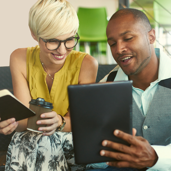 A man and woman viewing a tablet computer