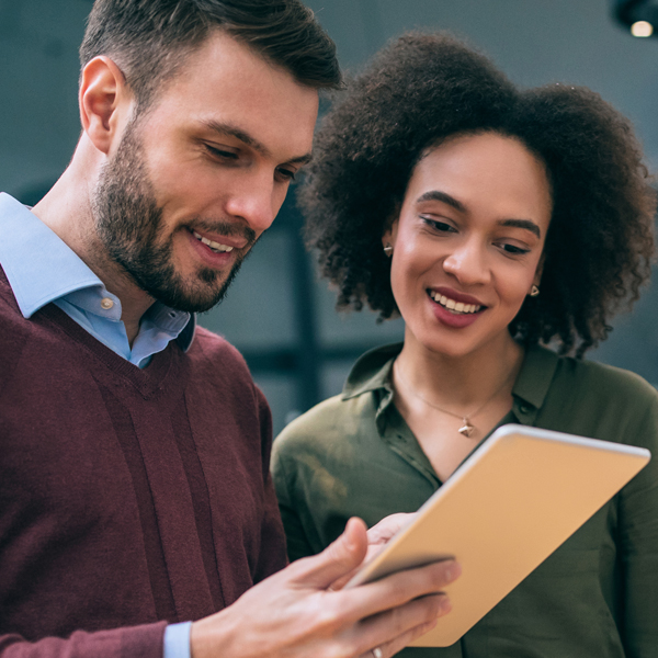 A man and woman viewing an notepad