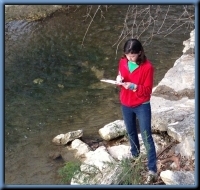 Colleting Data in the Gilleland Creek watershed; photo of a volunteer collecting data in the Gilleland Creek watershed