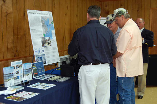 photo of stakeholders examining maps and literature